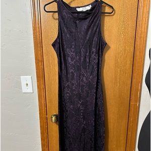 Full length, sleeveless, purple and black dress.